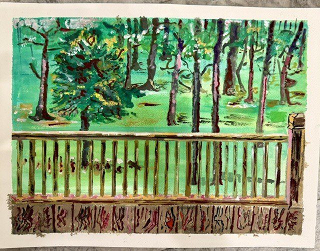 A student painting looking out through the porch rail into the woods.