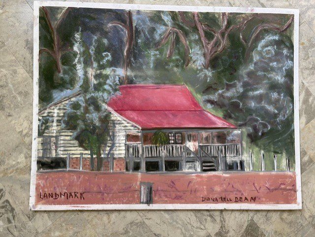 Landmark, a pastel by Diana Rell Dean of the raised cottage under its red roof.