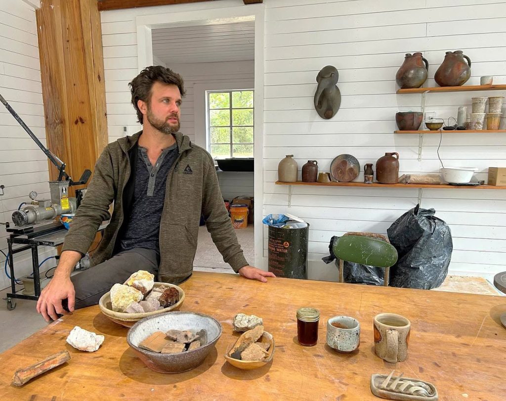 Potter Zach Sierke in a studio with handmade pottery and natural materials.
