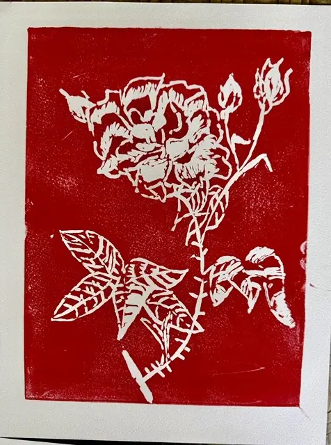 A red and white block print of a flowering branch
