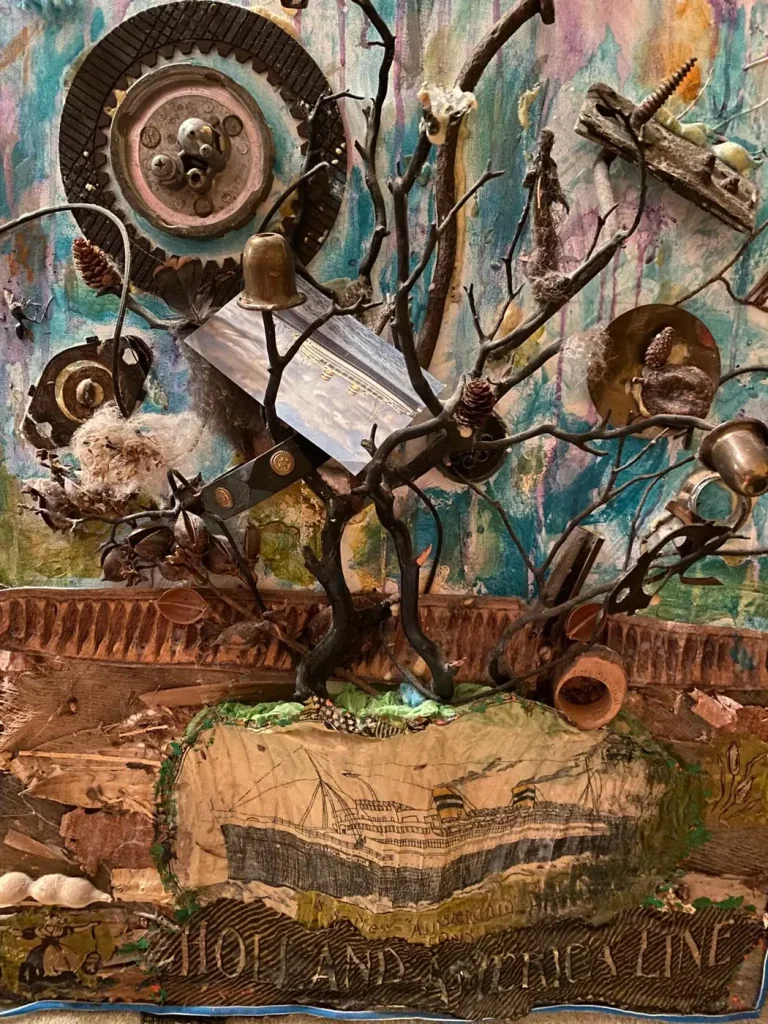 A mixed-media sculpture of a wire tree with found objects