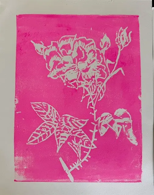 A pink and white block print of a rose