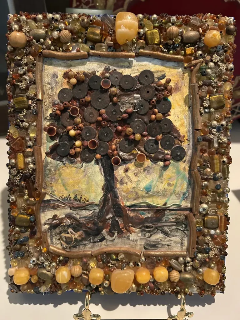 A mixed-media tree made of beads and buttons on canvas