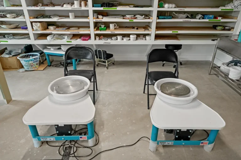 Shelves of ceramics and drying ware in the clay studio