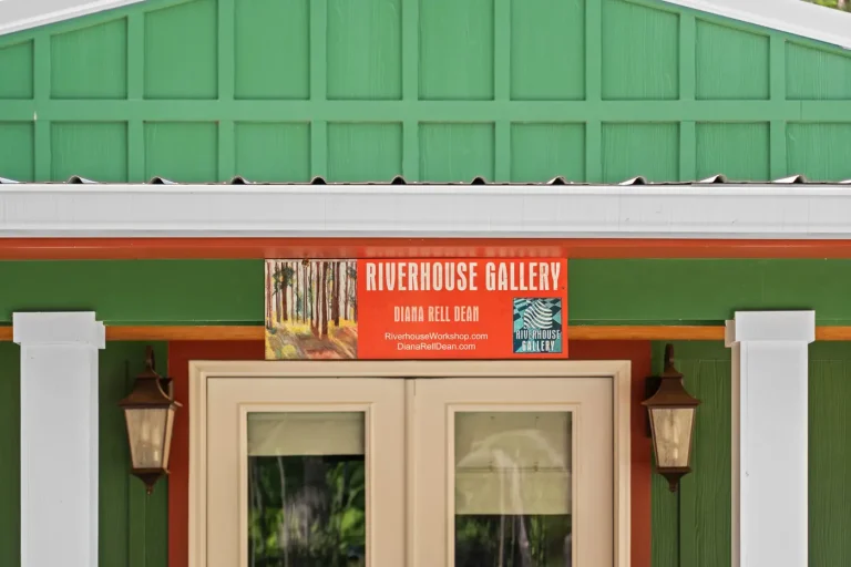 The Riverhouse Gallery entrance with a green facade and sign